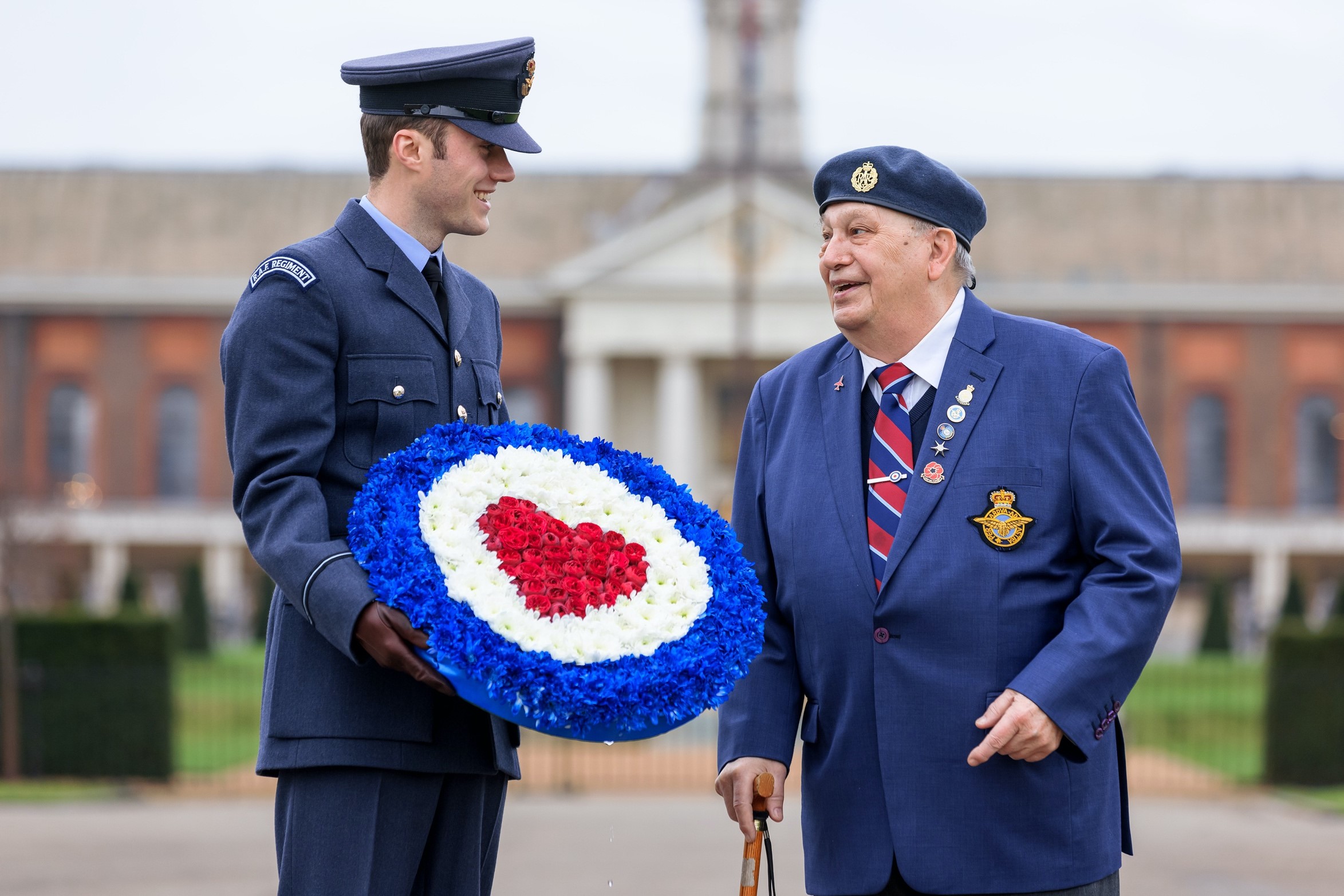 Veteran and Personnel talk with RAF roundel flower wreath.